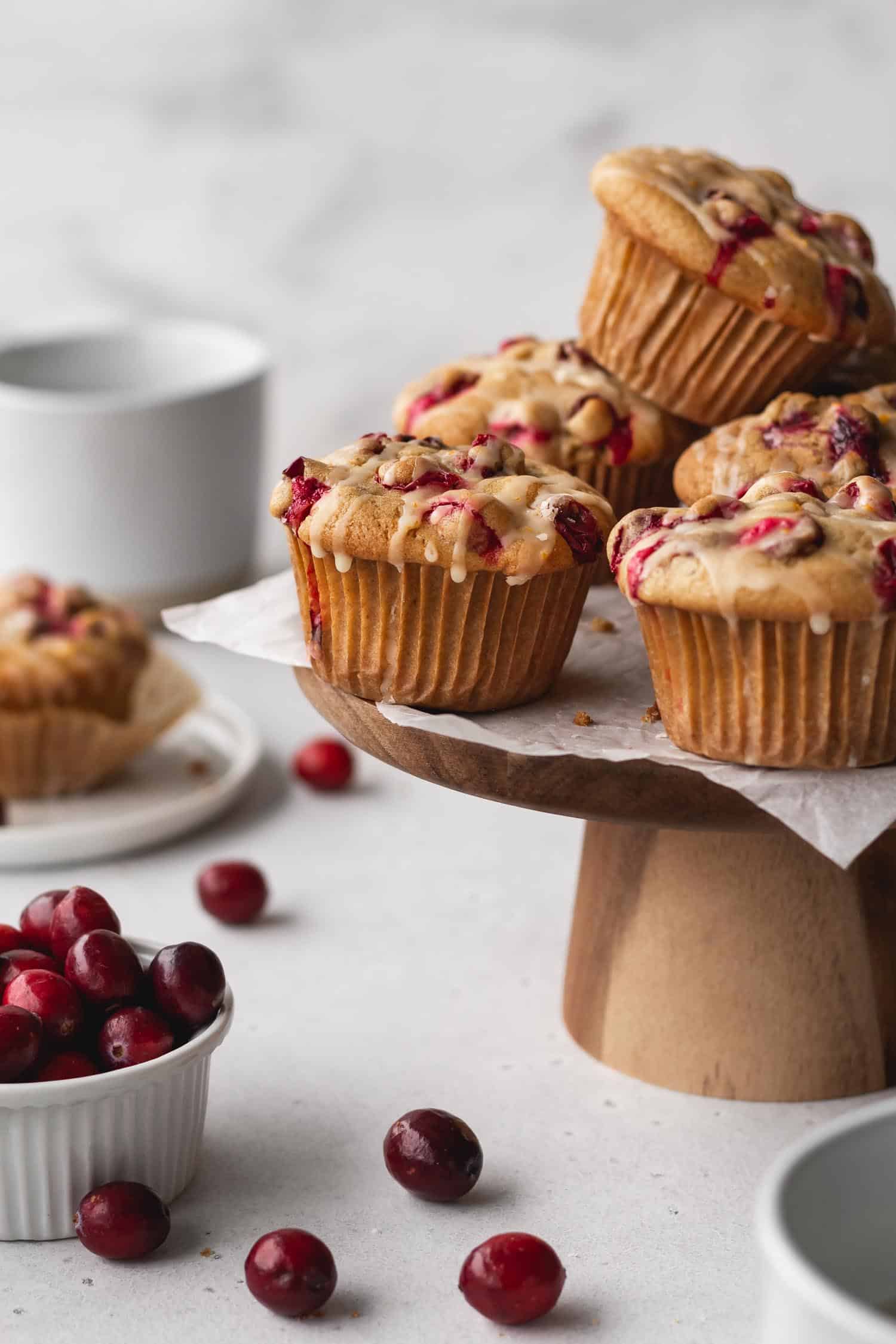 Gluten free cranberry orange muffins on a cake stand