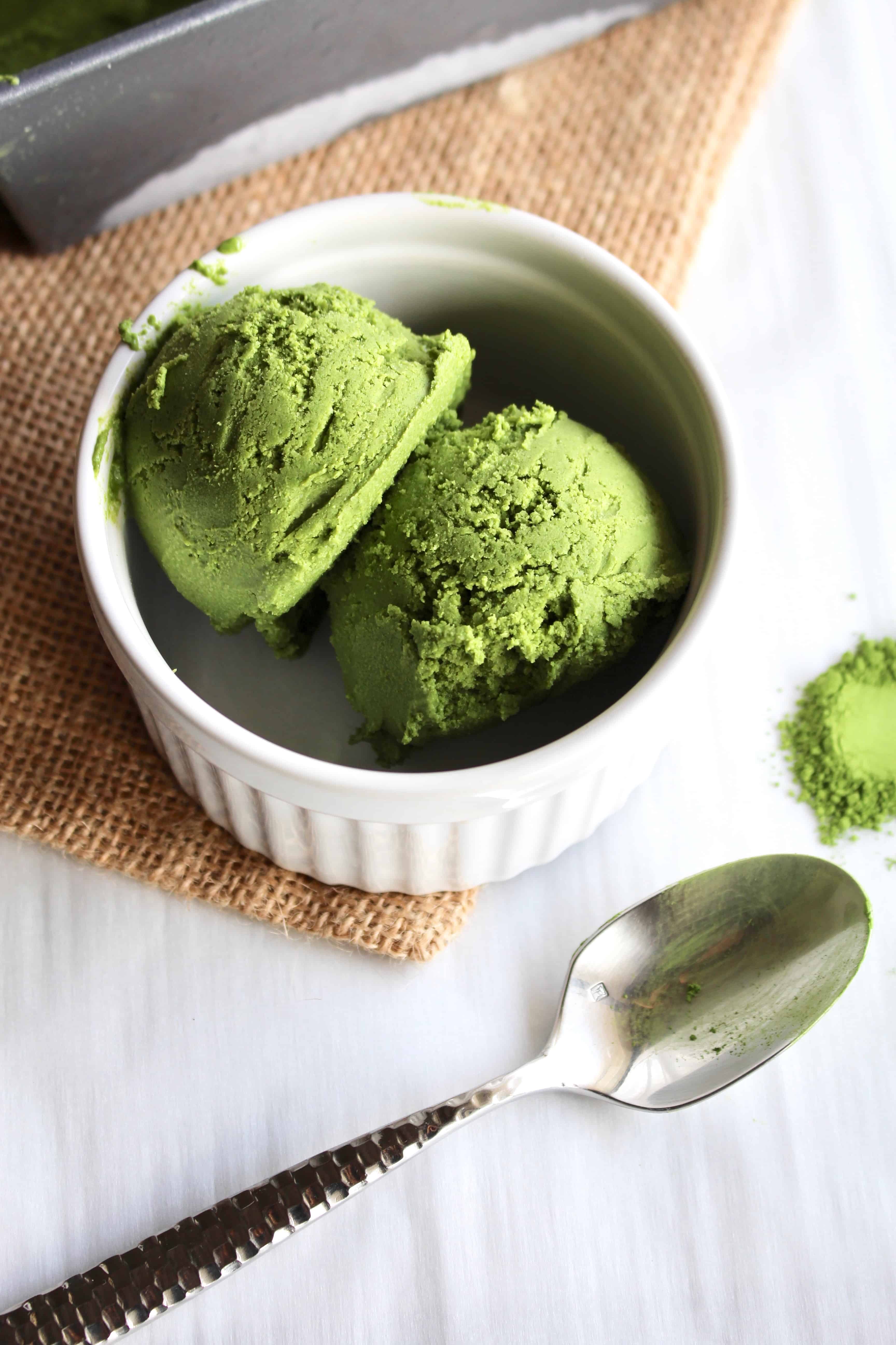 Vegan matcha ice cream scoops in a white dish