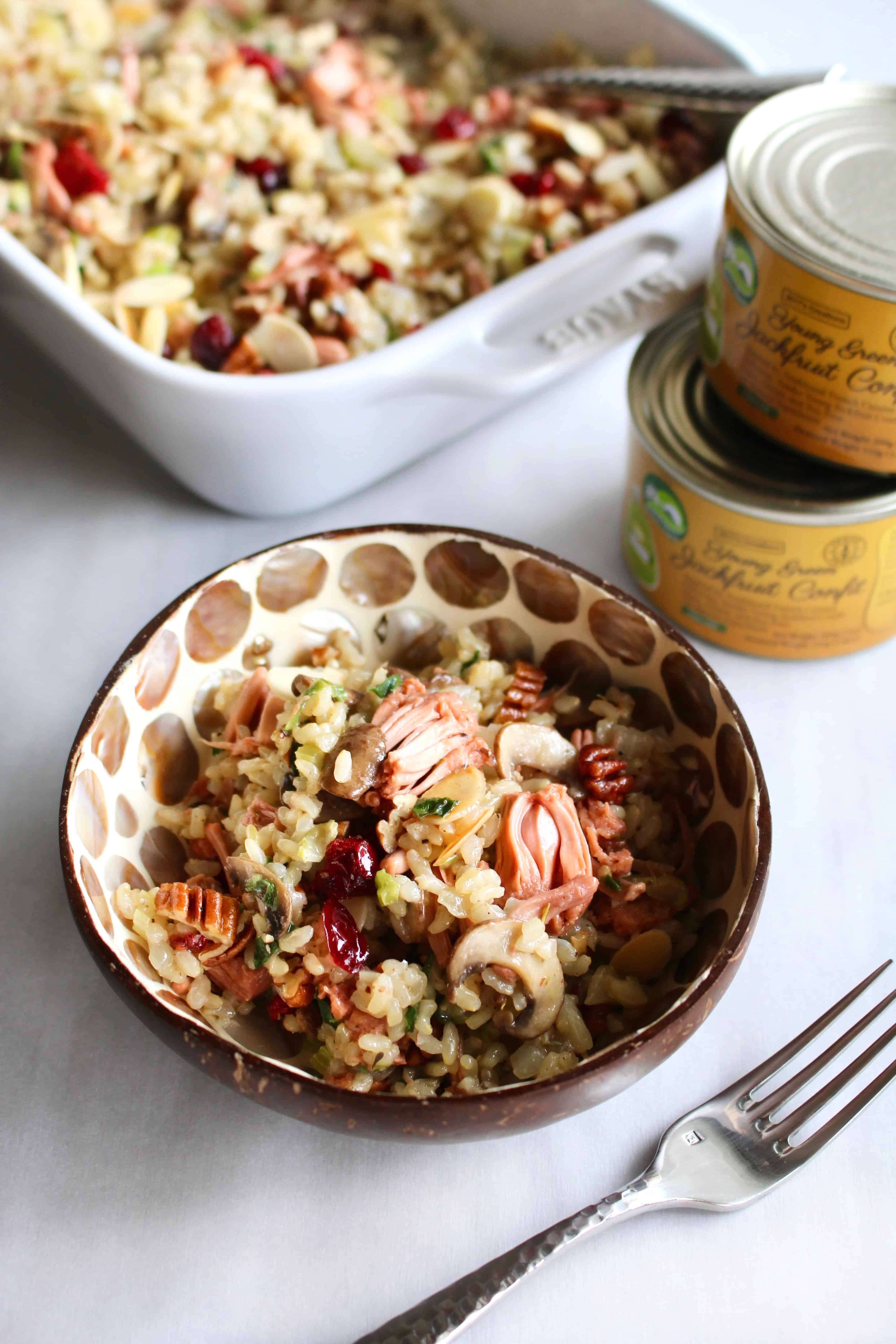 This rice stuffing with jackfruit is truly THE BEST stuffing ever! It’s both vegan and gluten free so everyone can enjoy it, making it perfect for the holidays when you have guests with different dietary restrictions. Full of brown rice, vegetables, cranberries, nuts, and jackfruit confit, there’s so much flavor in this stuffing you won’t be missing the meat! This is sure to be your new go to stuffing recipe for Thanksgiving and Christmas! #rice #ricestuffing #stuffing #thanksgiving #christmas #dinner #glutenfree #vegan #vegetarian #brownrice #easy #jackfruit #meatsubstitute #meatless #holidays #fall #winter #recipe #beststuffing #cranberries #almonds #pecans