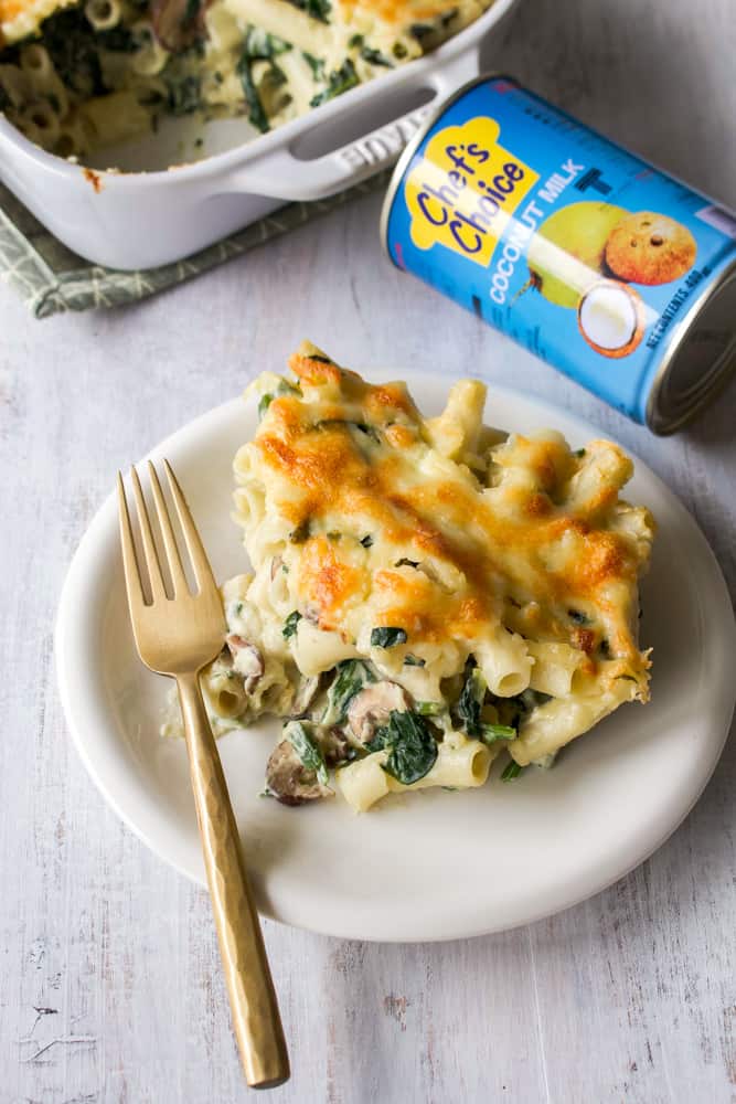 A plate of macaroni gratin with a gold fork.