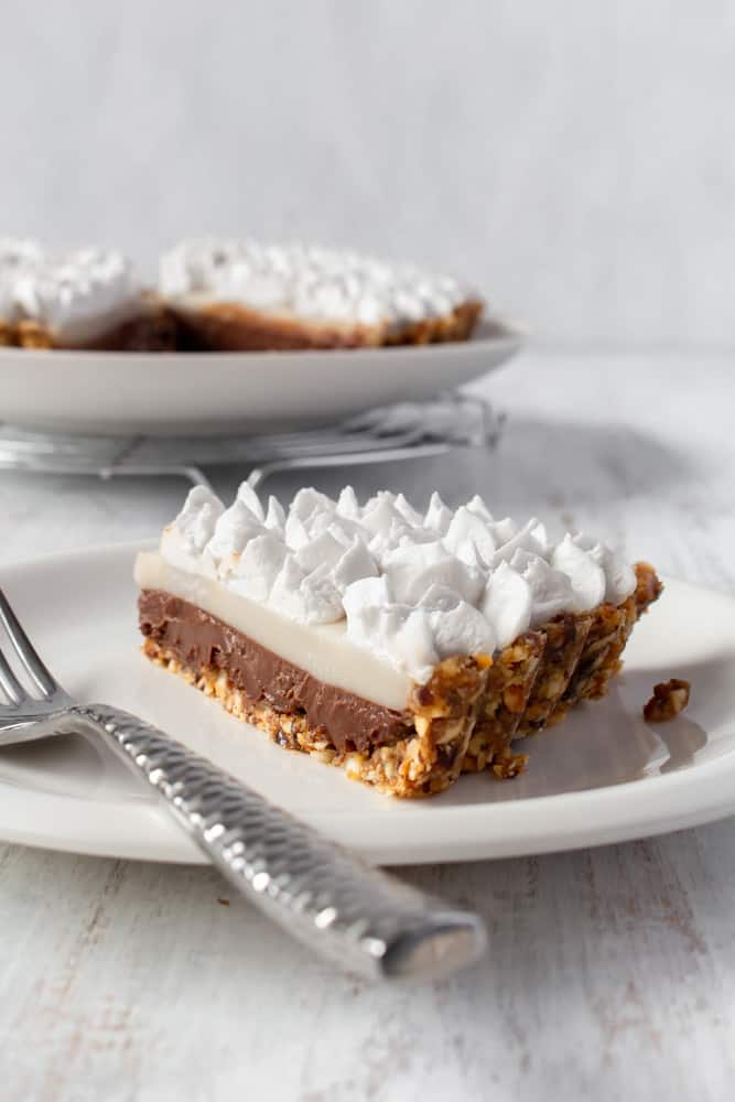 A slice of chocolate haupie pie on a plate.