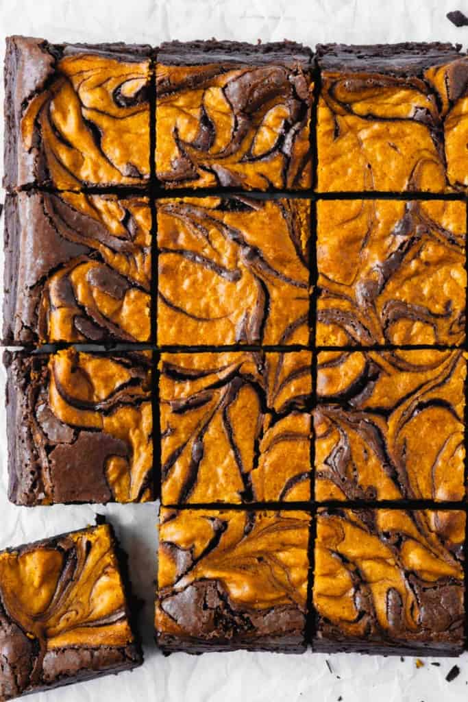 Close up of brownies with a pumpkin cheesecake swirl.