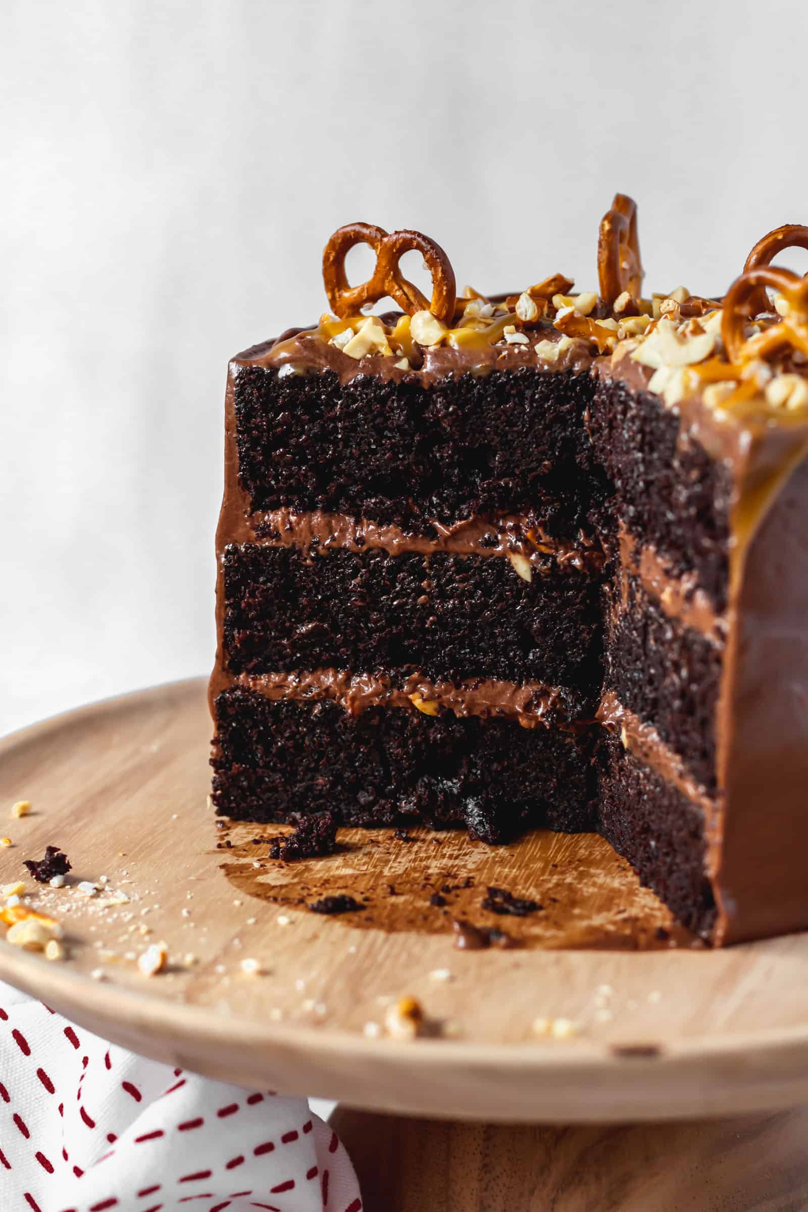 Moist and fluffy chocolate cake with peanuts, pretzels, and chocolate buttercream frosting