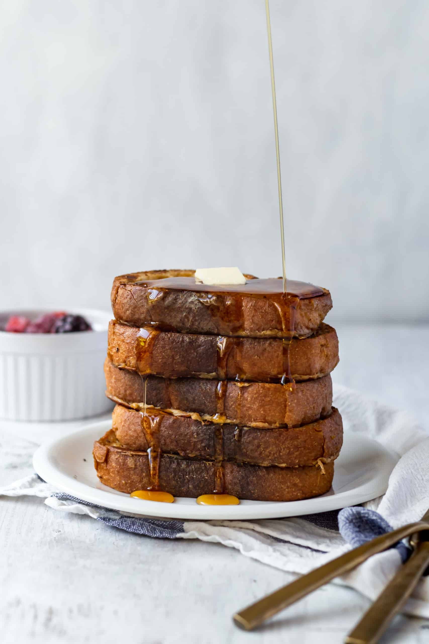 Vegan french toast is easy to make and shockingly delicious! Made with coconut milk and chickpea flour, it's perfect for breakfast or brunch! #veganfrenchtoast #veganbreakfast #veganbrunch #plantbasedmeals #frenchtoast