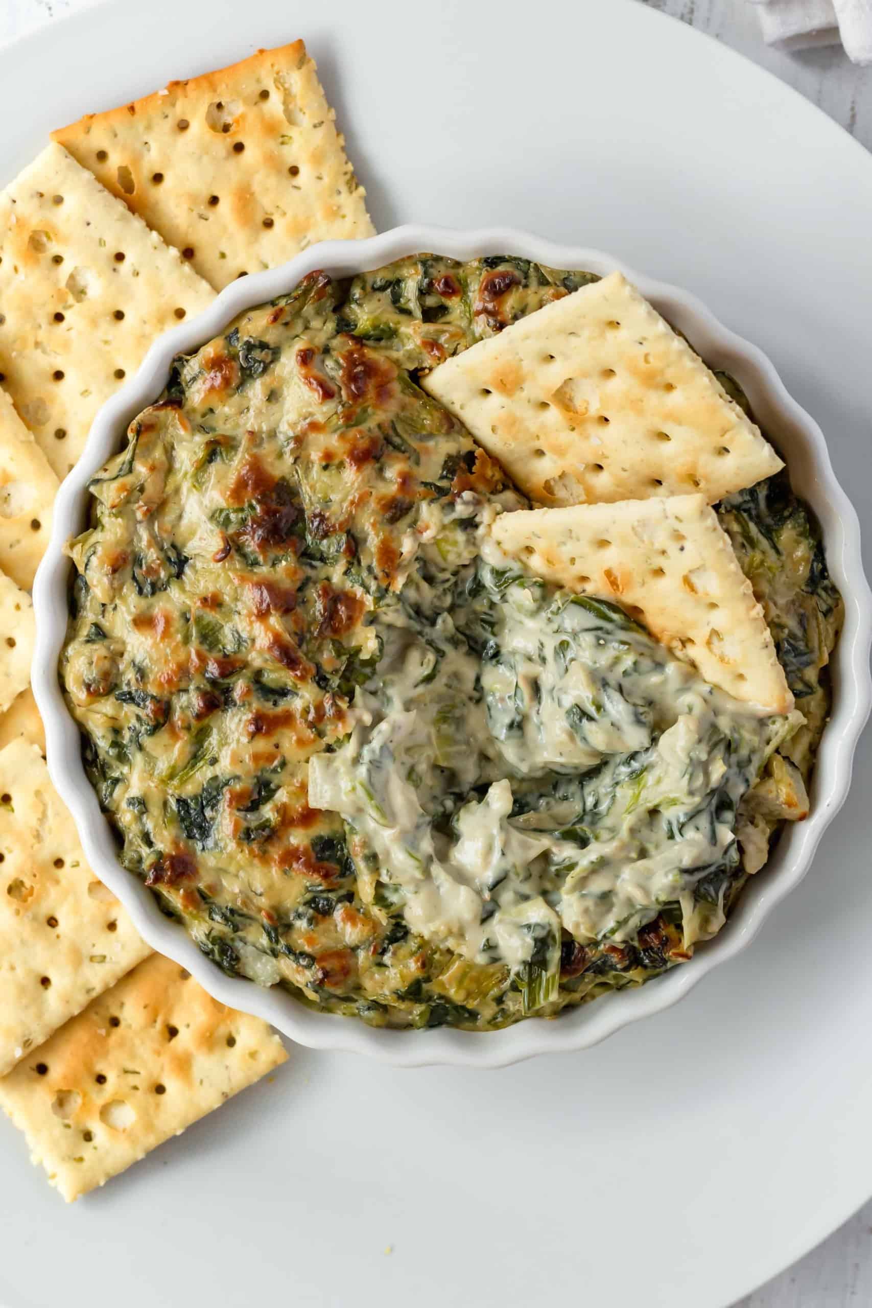 Overhead shot of creamy vegan spinach and artichoke dip.