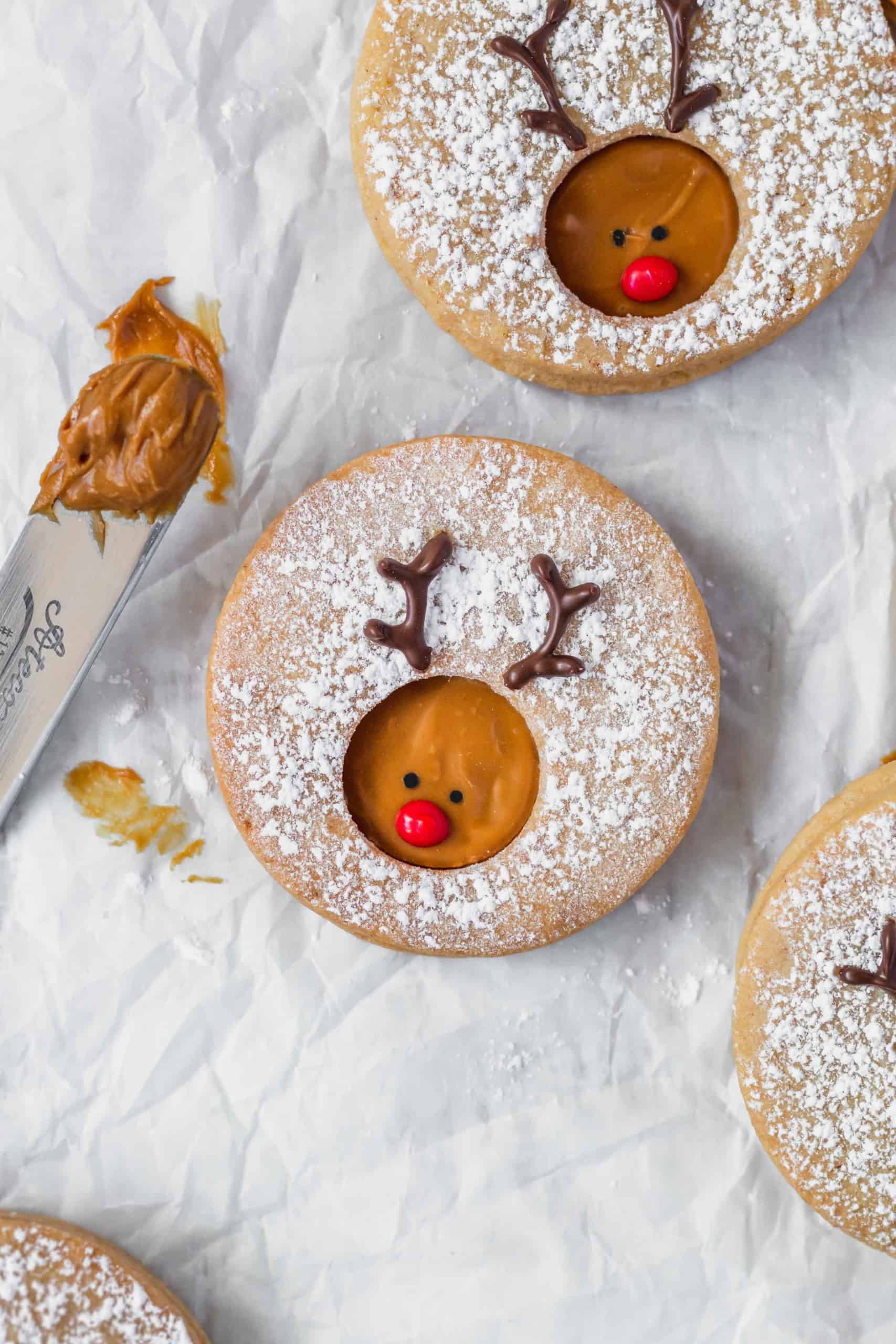 Rudolph reindeer cookies on a white surface.