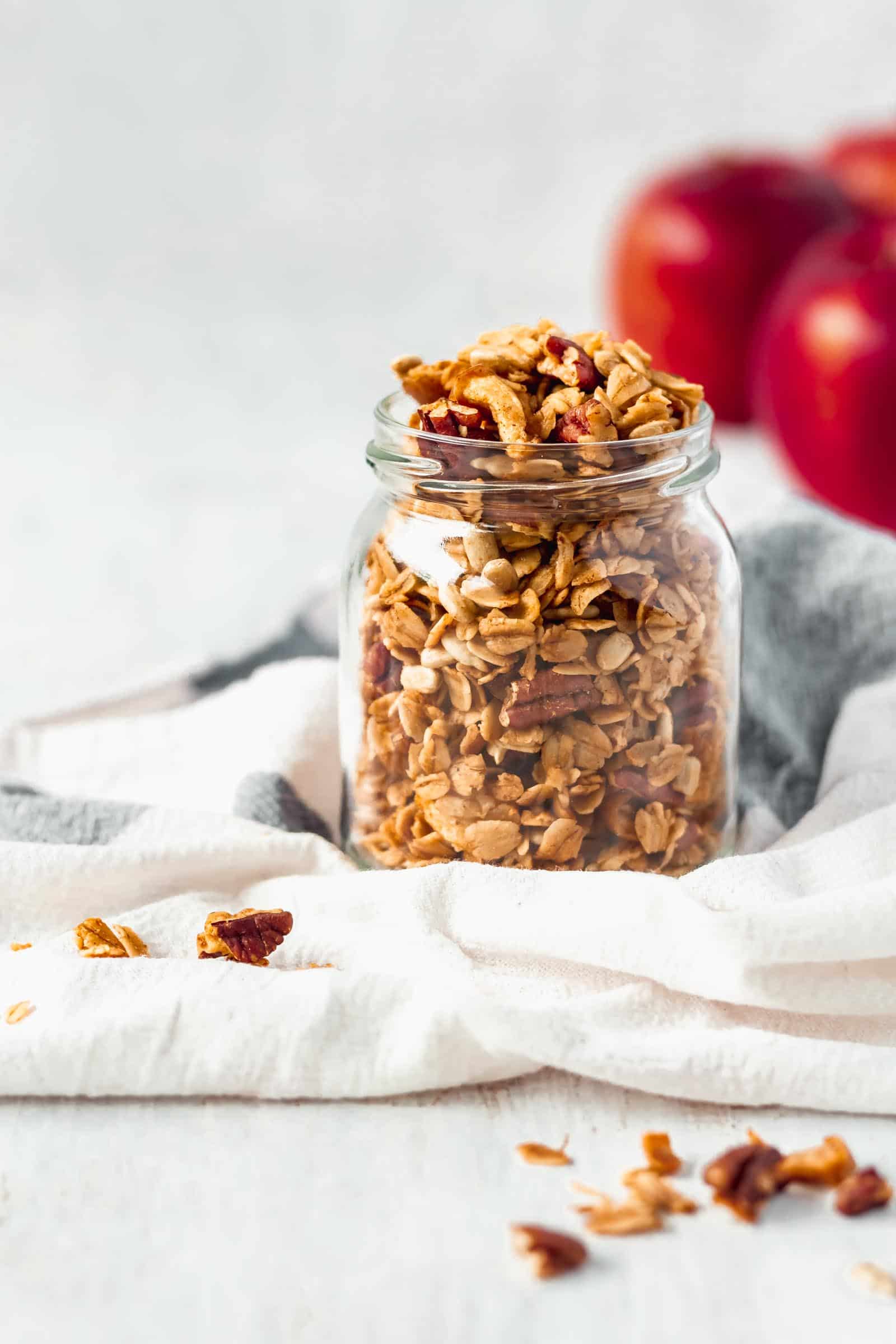 A fun twist on classic granola by adding apples and apple pie spice! A healthy breakfast while enjoying the comforting flavors of apple pie! #applepiegranola #cinnamonapplegranola #applegranola #homemadegranola #healthygranola