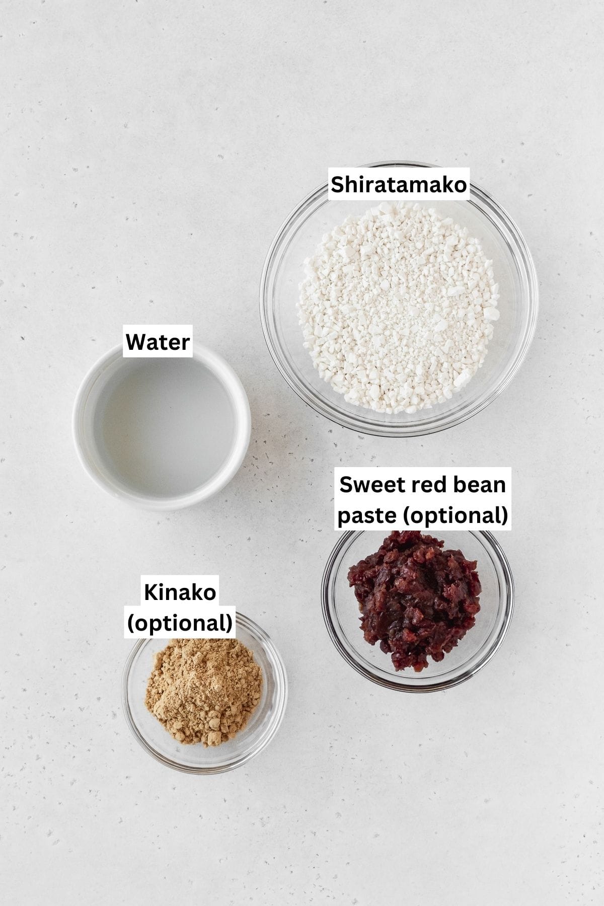 Ingredients to make shiratama measured into small bowls on a white surface.